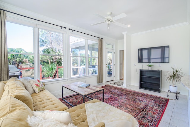 tiled living room with baseboards, plenty of natural light, ceiling fan, and crown molding