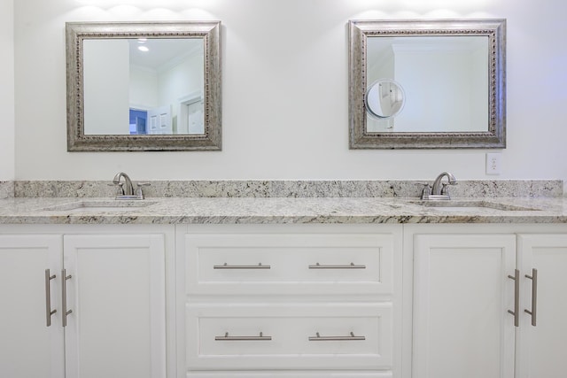 bathroom with a sink and double vanity