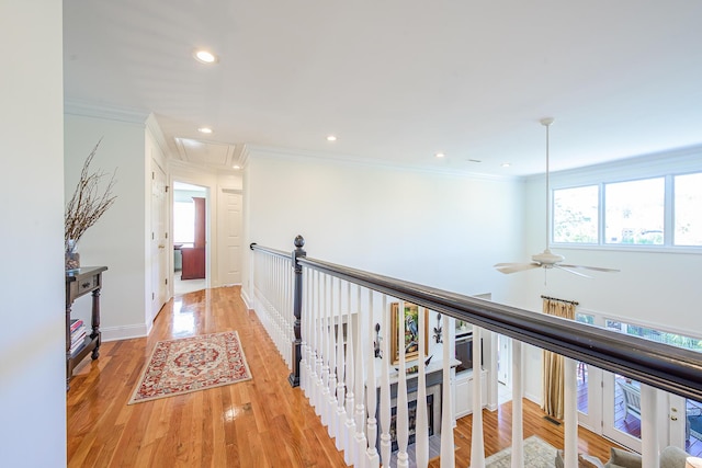 hallway featuring recessed lighting, attic access, light wood-type flooring, and ornamental molding