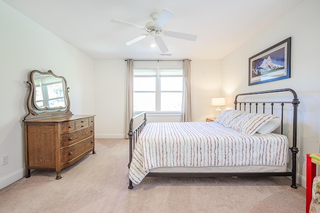 bedroom featuring light carpet, visible vents, a ceiling fan, and baseboards