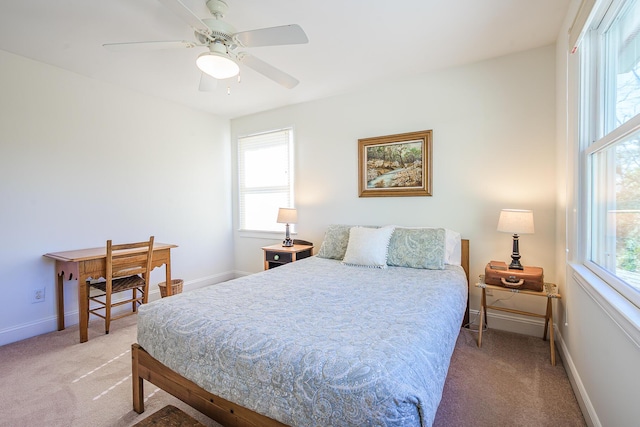 bedroom featuring a ceiling fan, baseboards, and light carpet