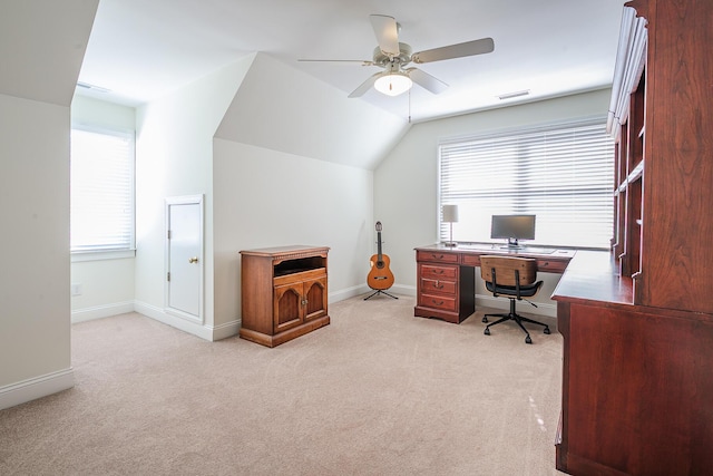 office space featuring visible vents, light colored carpet, baseboards, and vaulted ceiling