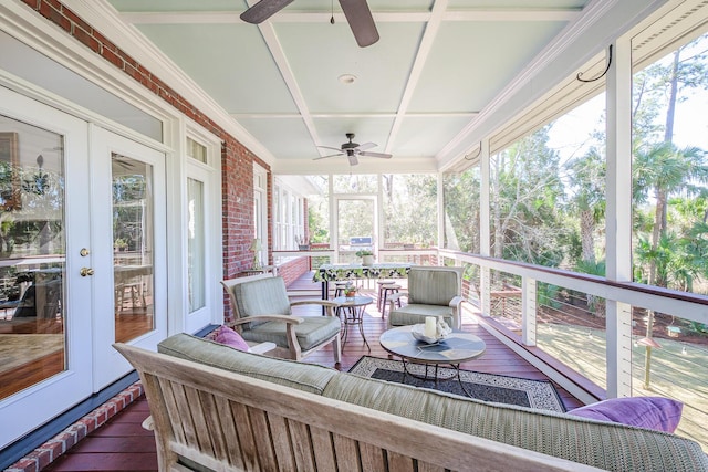 sunroom with plenty of natural light, coffered ceiling, and ceiling fan