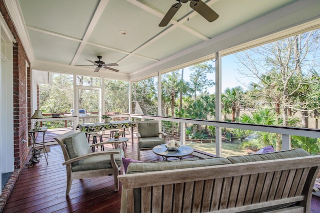 sunroom with coffered ceiling and a ceiling fan