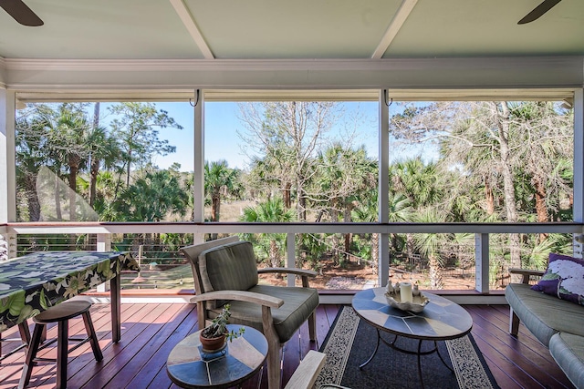 sunroom / solarium with a healthy amount of sunlight and ceiling fan