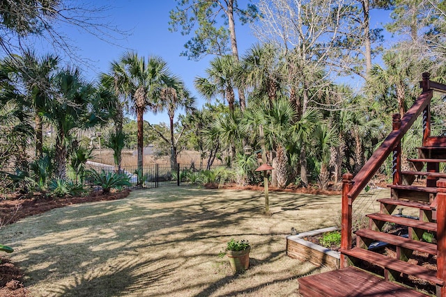 view of yard featuring stairway and fence