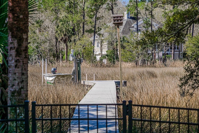 view of yard with fence and a boat dock