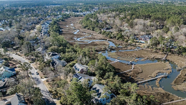 drone / aerial view featuring a forest view and a water view