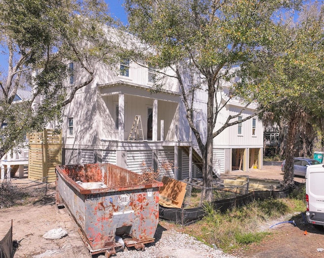 back of house featuring stairway