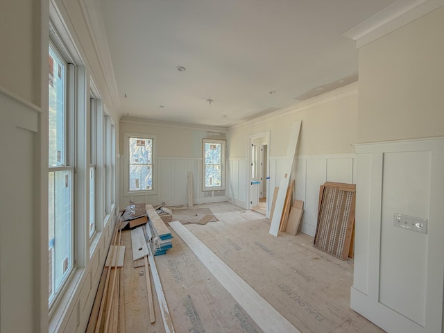 spare room with a wainscoted wall and ornamental molding