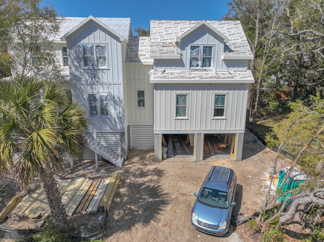 view of front facade with stairs and board and batten siding