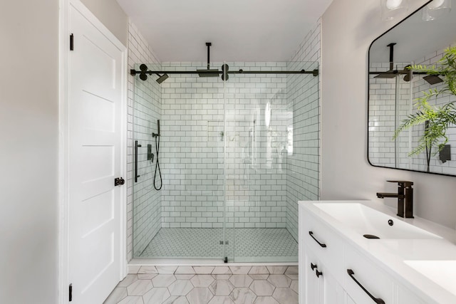 bathroom with tile patterned flooring, vanity, and walk in shower