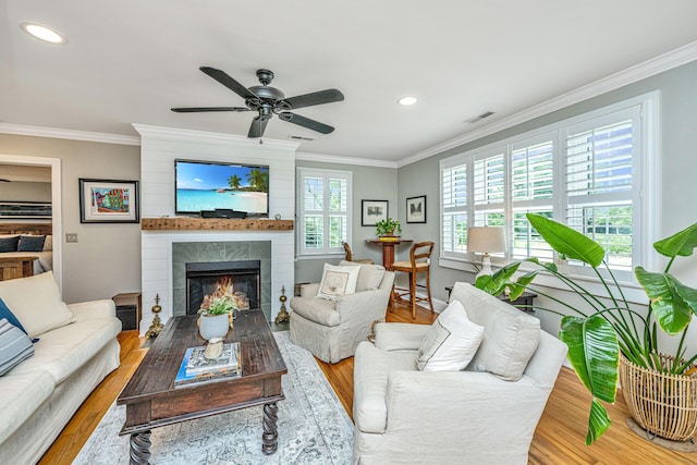 living room featuring ornamental molding, wood finished floors, and visible vents