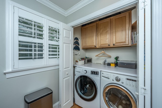 clothes washing area with independent washer and dryer, cabinet space, and crown molding