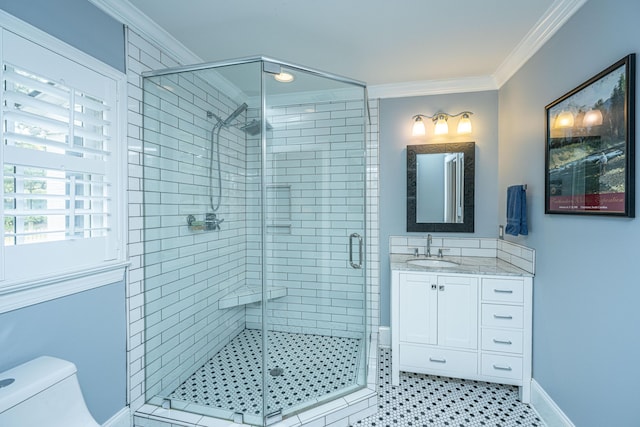 full bath featuring vanity, a shower stall, toilet, and crown molding