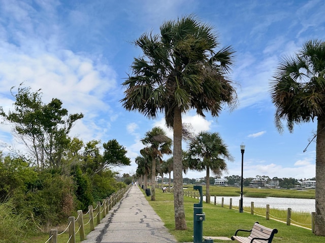 surrounding community featuring a water view and a yard