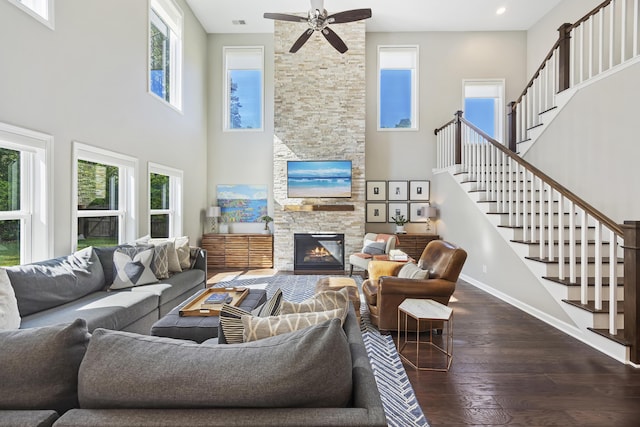 1166 Turkey Trot Dr, Johns Island, SC 29455 - living room with stairway, a towering ceiling, a fireplace, dark wood finished floors, and baseboards