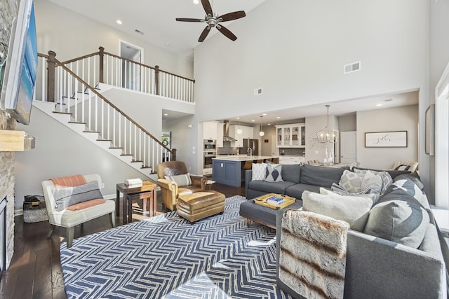 1166 Turkey Trot Dr, Johns Island, SC 29455 - living room featuring ceiling fan with notable chandelier, a towering ceiling, wood finished floors, and visible vents