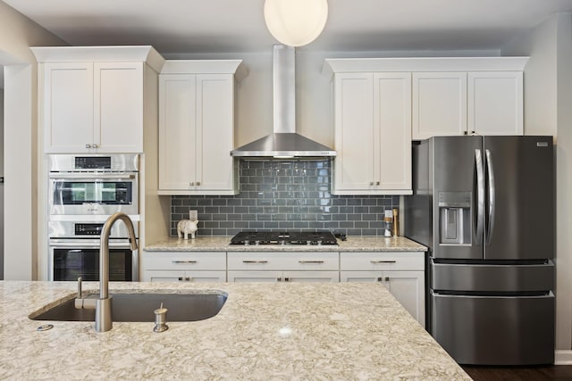 1166 Turkey Trot Dr, Johns Island, SC 29455 - kitchen with wall chimney range hood, appliances with stainless steel finishes, a sink, and white cabinetry