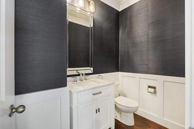 1166 Turkey Trot Dr, Johns Island, SC 29455 - half bathroom featuring a decorative wall, wood finished floors, wainscoting, vanity, and toilet
