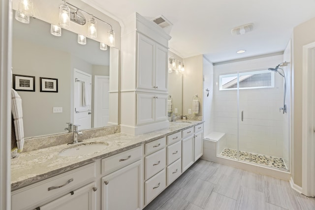 1166 Turkey Trot Dr, Johns Island, SC 29455 - bathroom with visible vents, a sink, double vanity, and a stall shower