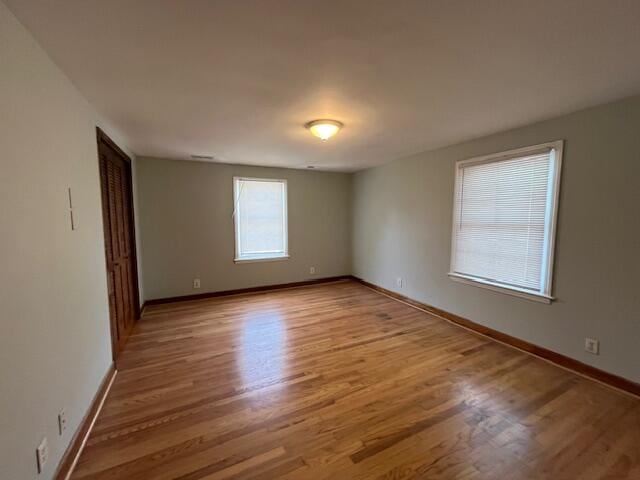 empty room with light hardwood / wood-style flooring