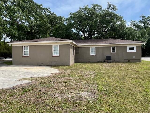 back of property featuring a yard, central AC unit, and a patio area