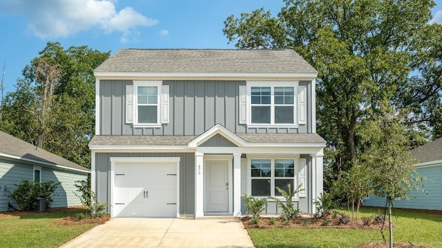 view of front facade with a garage and a front lawn