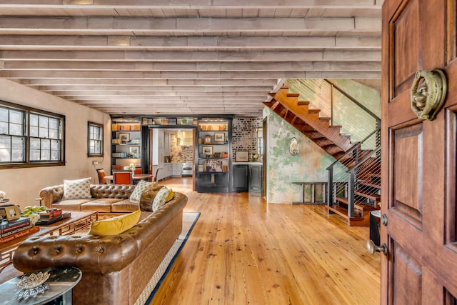 living room with beam ceiling, wooden ceiling, and light hardwood / wood-style flooring