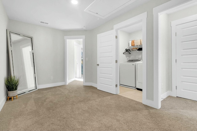 interior space with separate washer and dryer and light colored carpet