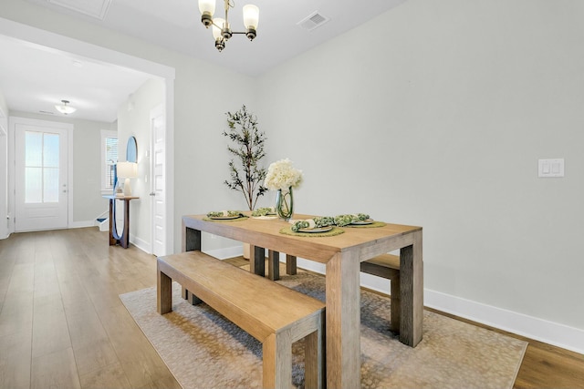 dining area featuring a chandelier and hardwood / wood-style flooring