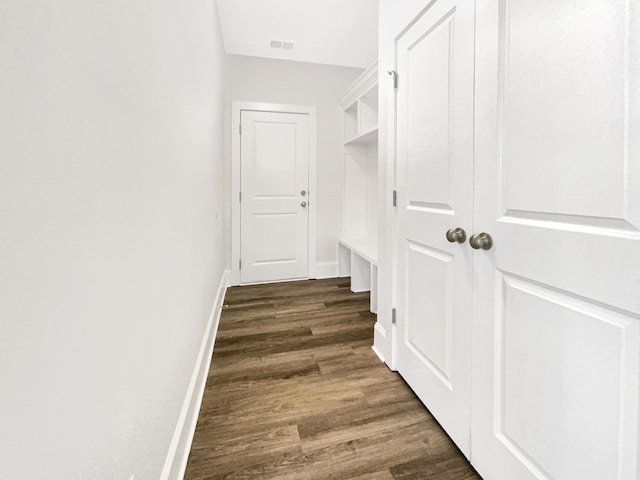 mudroom featuring visible vents, baseboards, and dark wood-type flooring