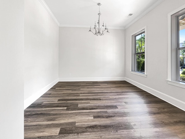 empty room with dark wood-style flooring, visible vents, baseboards, a chandelier, and ornamental molding