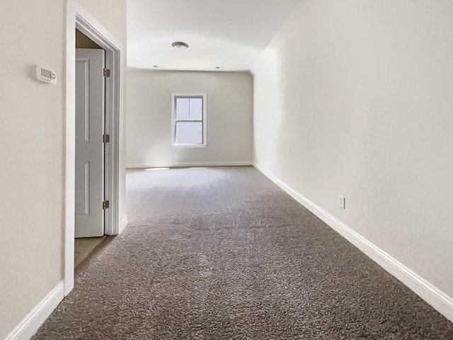 carpeted empty room with baseboards
