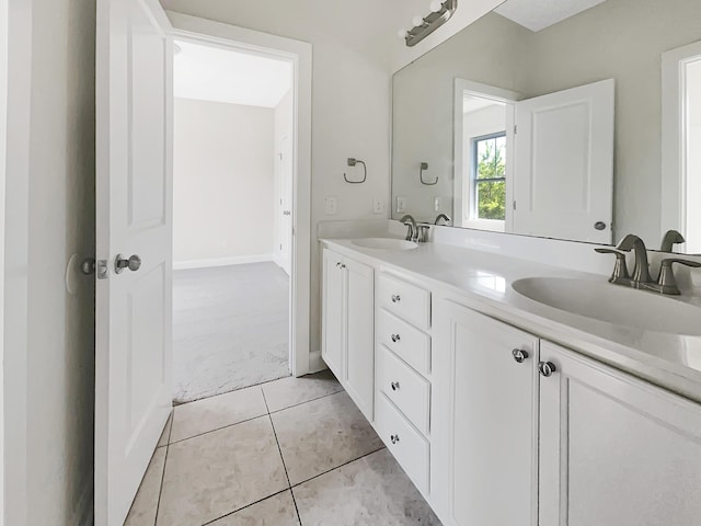 bathroom with double vanity, a sink, and tile patterned flooring