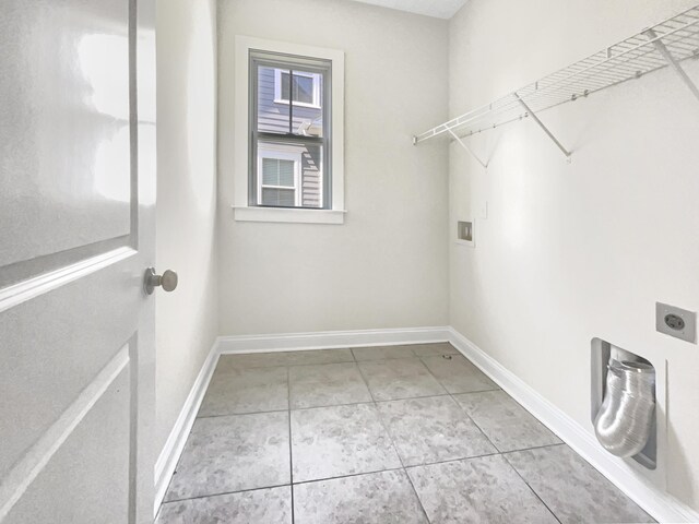 laundry room featuring laundry area, tile patterned flooring, hookup for a washing machine, baseboards, and hookup for an electric dryer