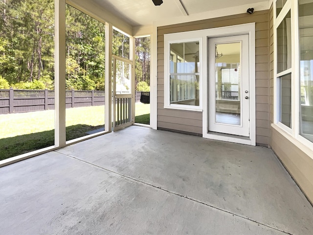 unfurnished sunroom with a ceiling fan