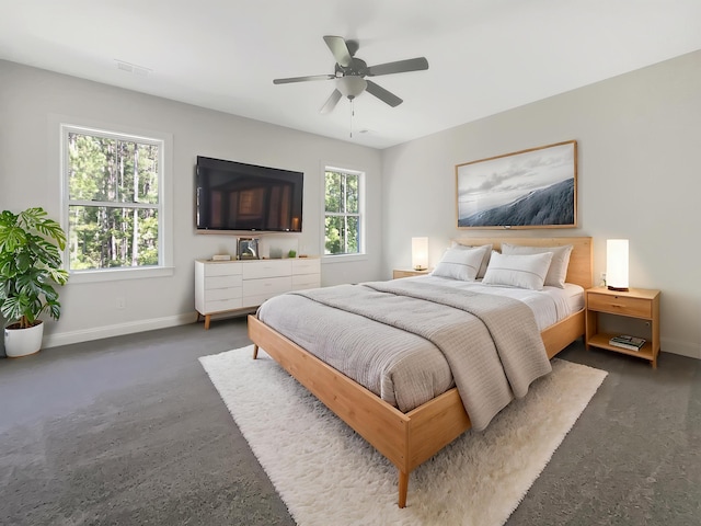 bedroom featuring baseboards, a ceiling fan, and visible vents