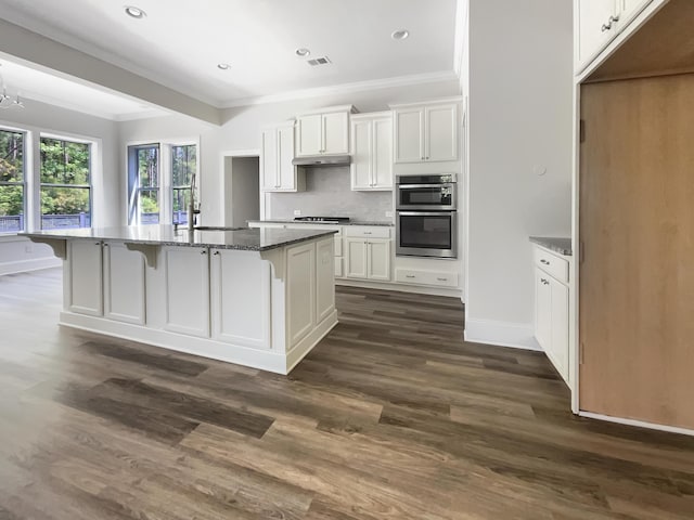 kitchen featuring a sink, cooktop, white cabinets, double oven, and ornamental molding