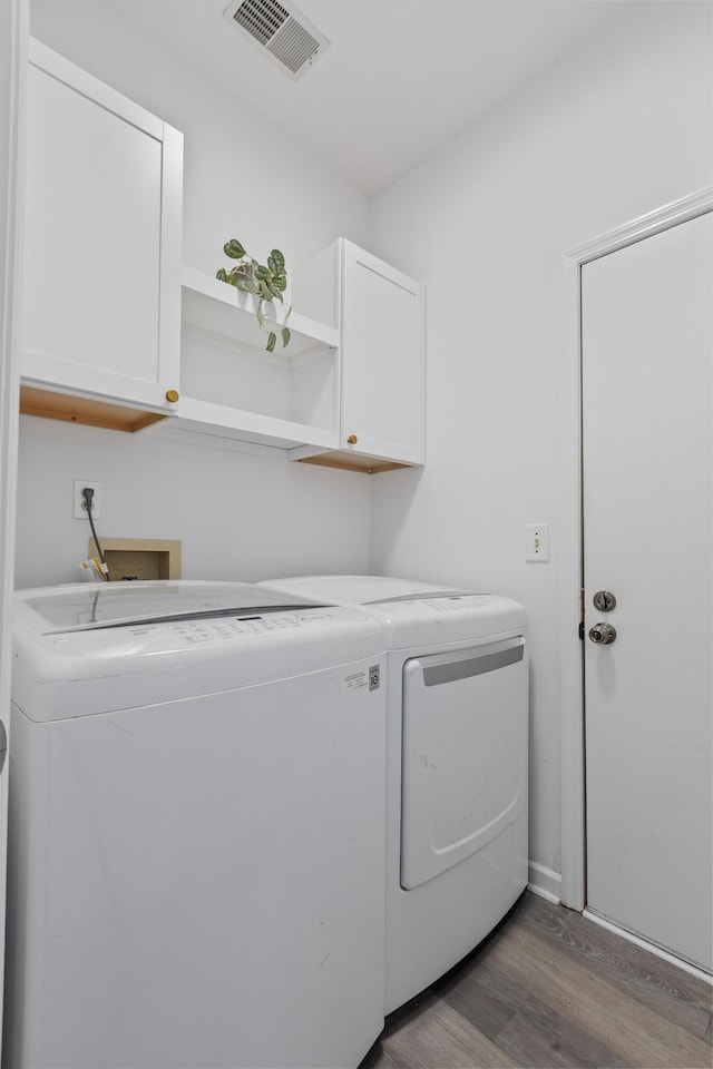 3202 Middleburry Ln, Charleston, SC 29414 - washroom featuring cabinet space, washing machine and dryer, and wood finished floors