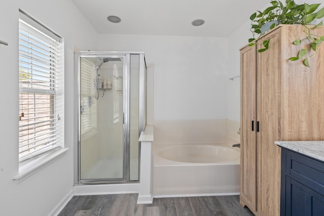 3202 Middleburry Ln, Charleston, SC 29414 - bathroom featuring wood finished floors, a stall shower, a garden tub, and vanity