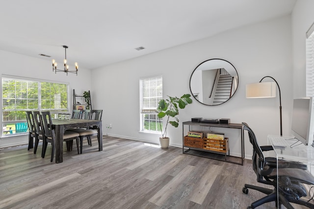 3202 Middleburry Ln, Charleston, SC 29414 - dining room featuring a chandelier, wood finished floors, healthy amount of natural light, and baseboards