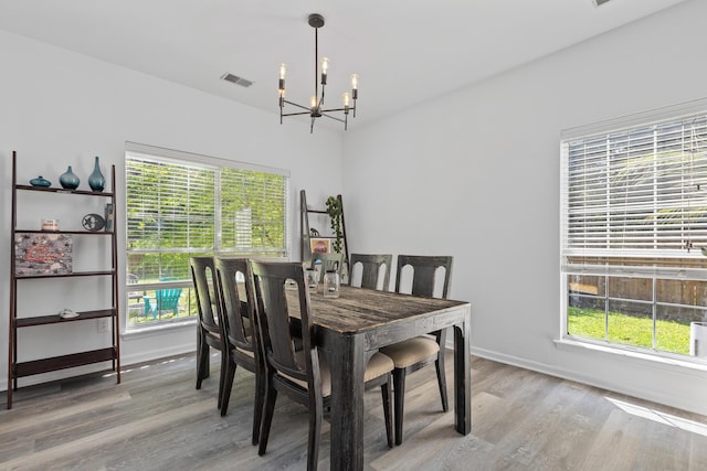 3202 Middleburry Ln, Charleston, SC 29414 - dining room with a chandelier, wood finished floors, plenty of natural light, and baseboards