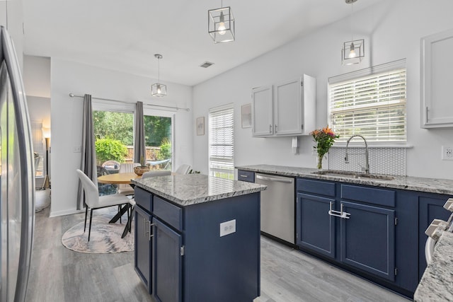 3202 Middleburry Ln, Charleston, SC 29414 - kitchen with blue cabinets, a sink, stainless steel appliances, and light wood finished floors