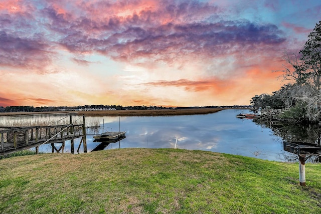 dock area featuring a water view and a yard