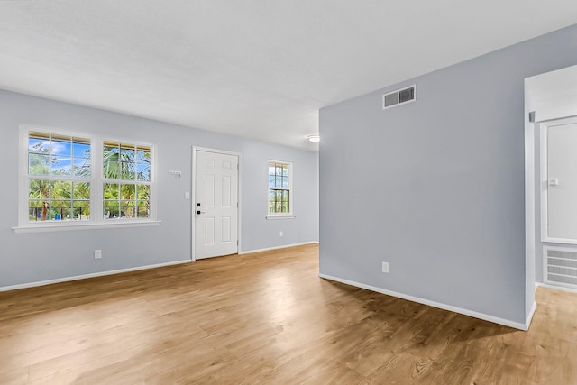 entryway featuring light wood-type flooring, visible vents, and baseboards