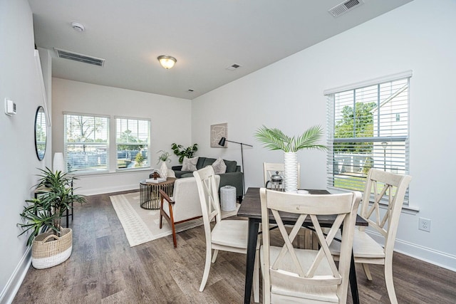 dining space featuring dark hardwood / wood-style flooring