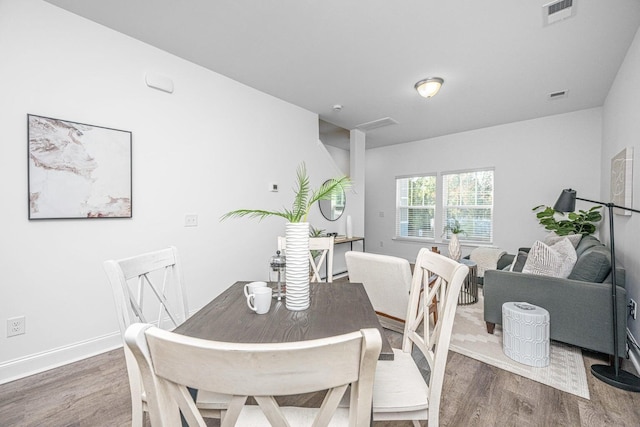 dining area with dark wood-type flooring