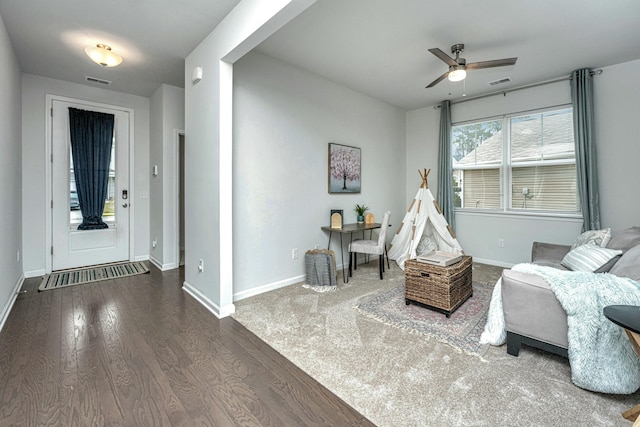 interior space with wood finished floors, visible vents, and baseboards