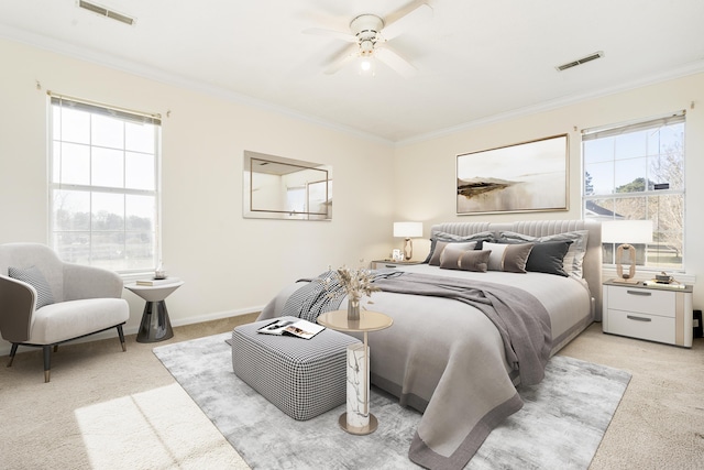 bedroom with ceiling fan, crown molding, and light colored carpet